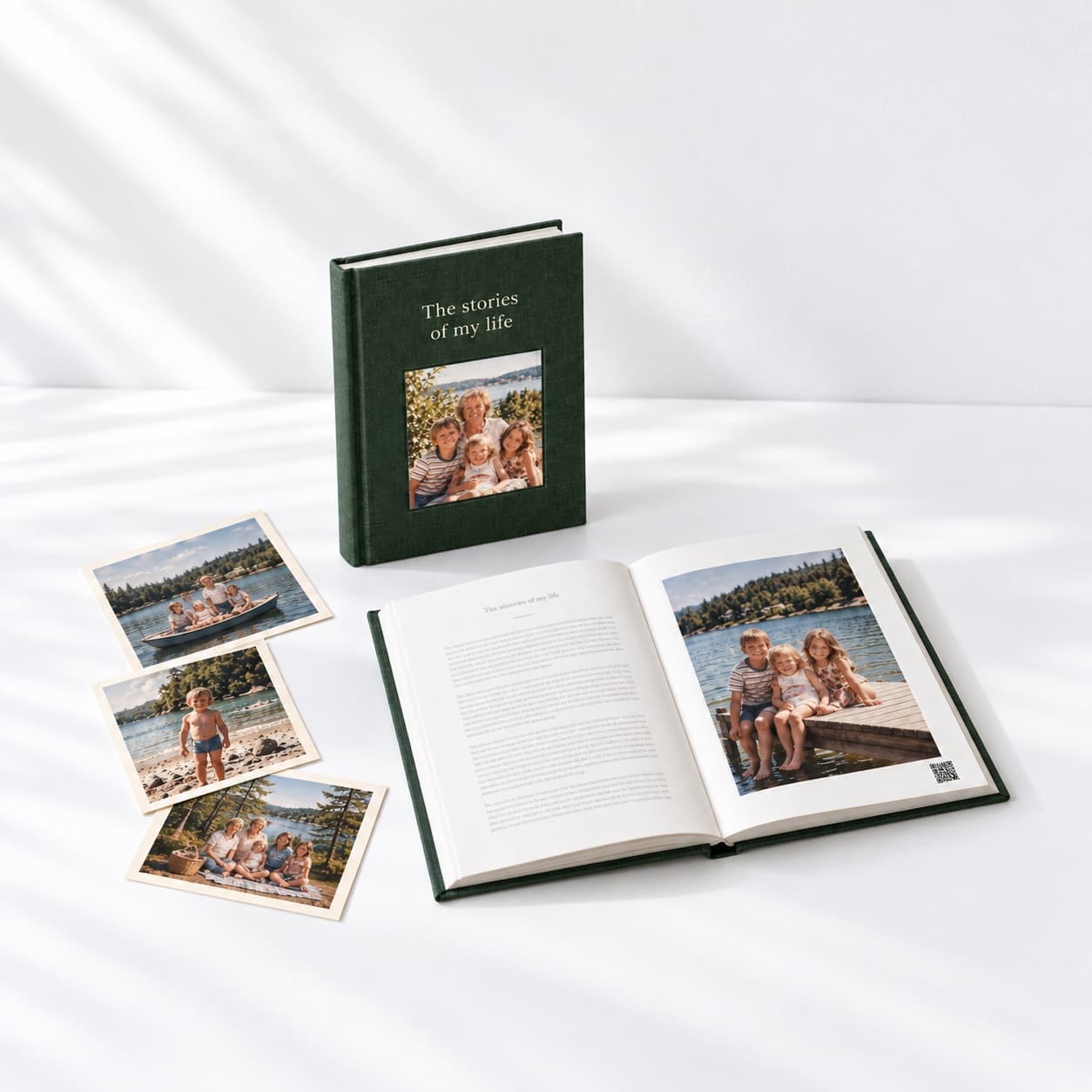 The finished book standing upright, with a second copy open to a printed story and a few family photos beside it
